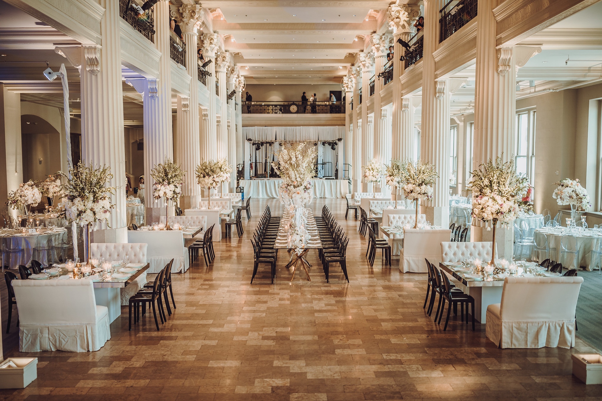 Elegant wedding reception hall adorned with floral centerpieces and candlelight, ready for guests.
